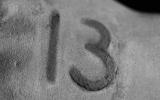 A burn in the form of the number "13" on the hand of one of the characters in the film